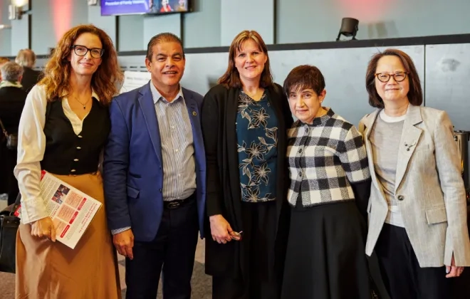 5 people posing in front of camera