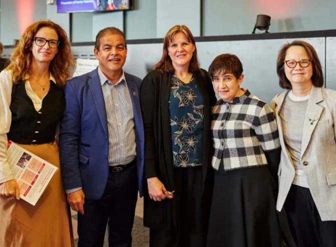 5 people posing in front of camera