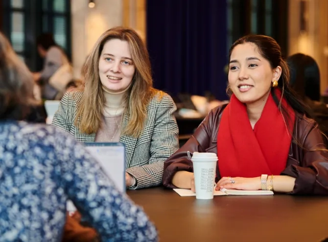 Two women talking to a third woman