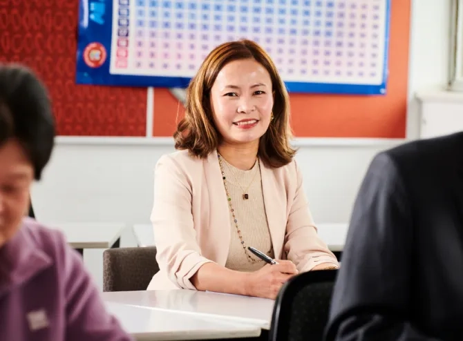 woman in class looking at camera